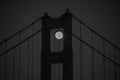 June 2022 Black and White Image of the full moon peaking through the north tower of the Golden Gate Bridge in San Francisco.