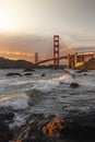 Golden Gate Bridge spanning over a tranquil body of water during a mesmerizing sunset