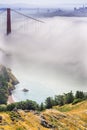 Golden Gate and the San Francisco bay covered by fog, the financial district skyline in the background, as seen from the Marin Royalty Free Stock Photo