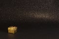 Golden gift box on black sparkling glittery background. Photo with selective focus. Backdrop with copy space Royalty Free Stock Photo