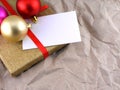 Golden gift box with red ribbon, christmas balls and empty card Royalty Free Stock Photo