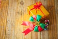 Golden gift box and red ribbon and Happy new year gift on wood b