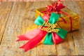 Golden gift box and red ribbon and Happy new year gift on wood b Royalty Free Stock Photo