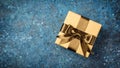 Golden gift box with shiny brown satin bow Royalty Free Stock Photo