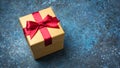 Golden gift box with shiny red satin bow Royalty Free Stock Photo