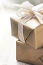 Golden gift boxes with beautiful ribbon and bow on a bright shiny background Royalty Free Stock Photo