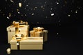 Golden gift boxes with falling sparkle on black background, christmas and anniversary concept Royalty Free Stock Photo