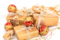 Golden gift boxes with golden ribbon and chrismas balls on white