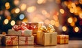 Golden gift boxes with ribbon bow tag over blurred bokeh background with lights. Birthday or Christmas decor. Blinking Royalty Free Stock Photo