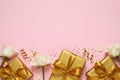 Golden gift boxes, white roses, confetti and streamers on pink background, flat lay. Space for text Royalty Free Stock Photo