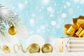 Golden gift or present box on magic bokeh background. Holiday composition for Christmas or New Year.