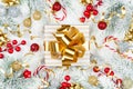 Golden gift or present box, snowy fir tree and christmas decorations on white wooden table top view. Flat lay. Royalty Free Stock Photo