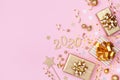 Golden gift or present boxes, 2020 numbers and Christmas decorations on pink background top view. Flat lay Royalty Free Stock Photo