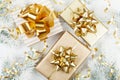 Golden gifts or presents boxes, snowy fir tree and christmas decorations on white wooden table top view. Flat lay. Royalty Free Stock Photo