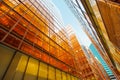 Golden glass facade of modern  office building and blue sky Royalty Free Stock Photo