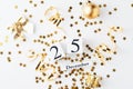 Golden glitter confetti and decorations on a white background