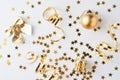 Golden glitter confetti and decorations on a white background
