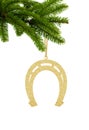 Golden Glitter Decorative Horseshoe on Green Christmas Fir Tree isolated on White Royalty Free Stock Photo