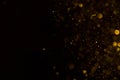 Golden glitter falling sparkle background on black Royalty Free Stock Photo