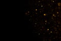 Golden glitter falling sparkle background on black Royalty Free Stock Photo