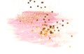 Golden glitter and glittering stars on abstract pink watercolor splash on white background