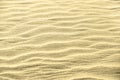 Golden glitter on sand background