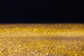 Golden glitter sand rain texture on black, abstract background. Royalty Free Stock Photo