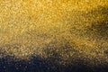 Golden glitter sand texture on black, abstract background. Royalty Free Stock Photo