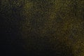 Golden glitter sand texture on black, abstract background. Royalty Free Stock Photo