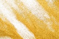 Golden glitter sand texture on white, abstract background. Royalty Free Stock Photo