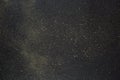 Golden glitter and stars scattered on the black background. Black glitter texture christmas abstract background. Royalty Free Stock Photo