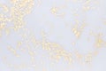 Golden glitter on white surface as future modern abstract background.