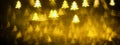 Golden glittering background with Christmas trees. Sparkle glitter texture with the bokeh and the lights Royalty Free Stock Photo