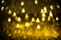 Golden glittering background with Christmas trees. Sparkle glitter texture with the bokeh and the lights Royalty Free Stock Photo