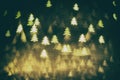 Golden glittering background with Christmas trees. Sparkle glitter texture with the bokeh and the lights Royalty Free Stock Photo