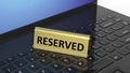 Golden glossy reservation sign on laptop keyboard