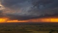 Golden Glow Under Ominous Clouds, Flatlands Stretched Before the Approaching Storm. Royalty Free Stock Photo