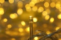 Golden glowing Christmas lights on blurred background Royalty Free Stock Photo