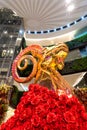 Golden goat staue with red rose in shopping mall in Bangkok