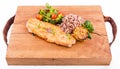 Golden grilled fish fillet with a side dish of rice and vegetables on a wooden board on a white background Royalty Free Stock Photo