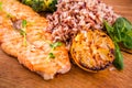 Golden grilled fish fillet with a side dish of rice and vegetables on a wooden board on a white background Royalty Free Stock Photo