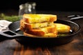 golden grilled sandwiches under a weighty brick on a skillet