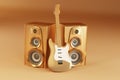 Golden guitar and louspeakers on yellow background