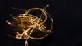 Golden Gyroscope Spinning Wildly on its Base Royalty Free Stock Photo