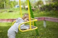 Golden-haired little girl gathered to climb out on the swing Royalty Free Stock Photo