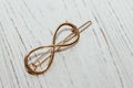Golden hairpins on wood background, social media content.