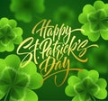 Golden handwriting lettering Happy Saint Patricks Day on green background made of realistic clover leaves and golden