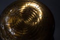 Golden hang drum on a black background, closeup, selective focus