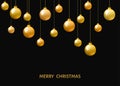 Golden hanging Christmas balls isolated on black background.