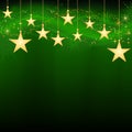 Golden hanging stars on dark green background Royalty Free Stock Photo
